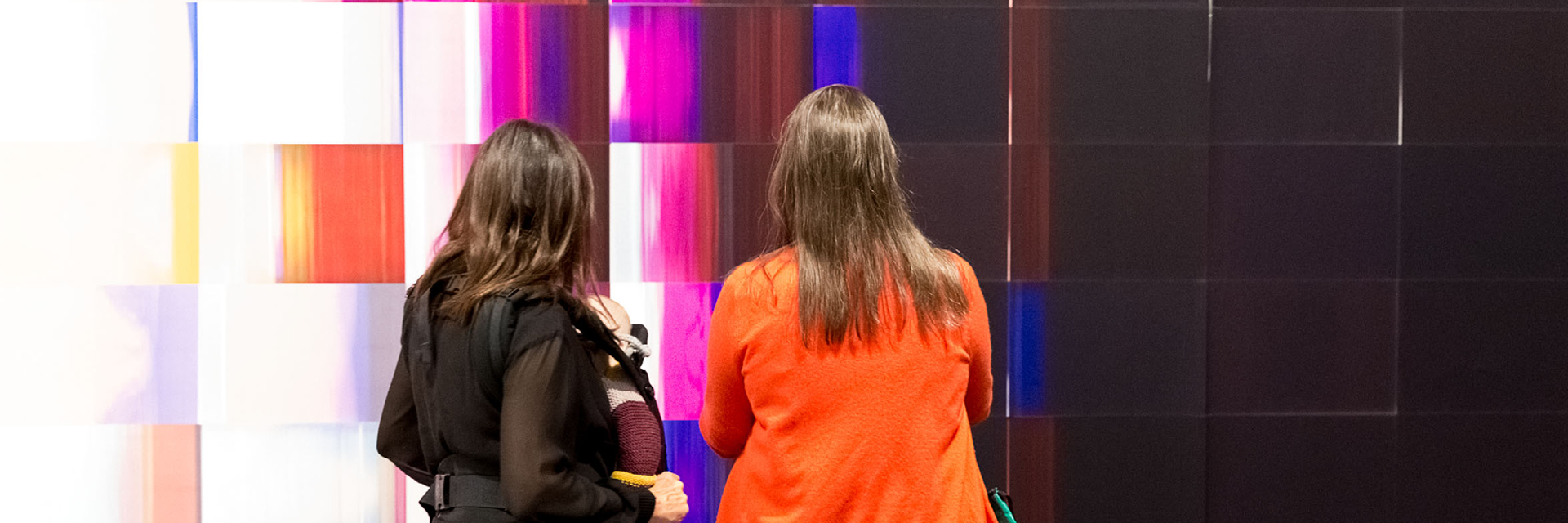 two visitors looking at Caline Aoun's work ${esc.q}Contemplaiting Dispersions${esc.q}